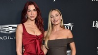 Dua Lipa dan Margot Robbie memancarkan pesona yang berbeda. (Foto: AFP/LISA OCONNOR)