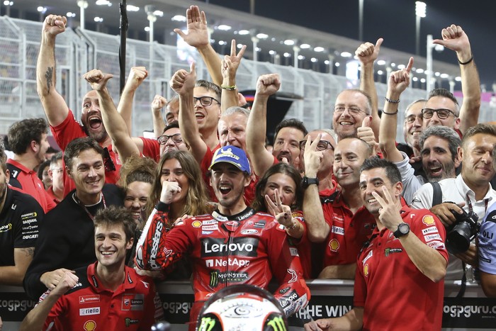 Second placed, Ducati rider Francesco Bagnaia, of Italy, center, celebrates with his teammates end of the Qatari MotoGP Grand Prix at the Lusail International Circuit in Lusail, Qatar, Sunday, Nov. 19, 2023. (AP Photo/Hussein Sayed)
