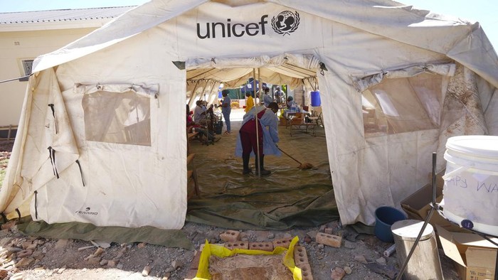 A family is seen entering a tent set aside for cholera patients at a clinic in Harare, Zimbabwe, Saturday Nov. 18, 2023. Zimbabwe is battling a cholera outbreak that has resulted in more than 150 suspected deaths countrywide. Health experts, authorities and residents blame the outbreak on acute water shortages and lack of access to sanitation and hygiene services (AP Photo/Tsvangirayi Mukwazhi)