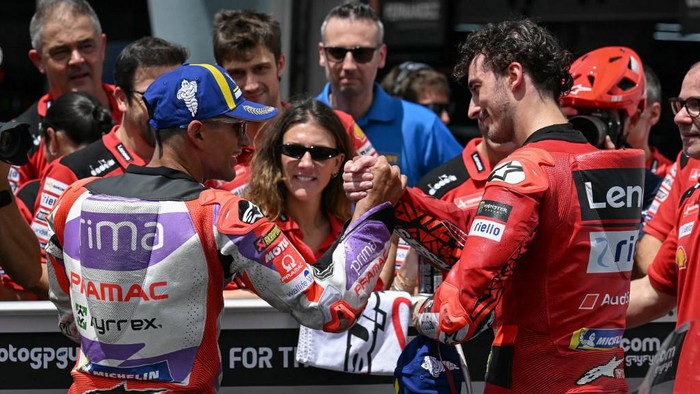 Ducati Lenovo Teams Italian rider Francesco Bagnaia (R) celebrates securing pole position with second place Prima Pramacs Spanish rider Jorge Martin (L) after the qualifying session of the MotoGP Malaysian Grand Prix at the Sepang International Circuit in Sepang on November 11, 2023. (Photo by MOHD RASFAN / AFP)