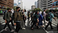 Warga yang mayoritas pekerja sedang menyeberangi Jalan Thamrin.  
