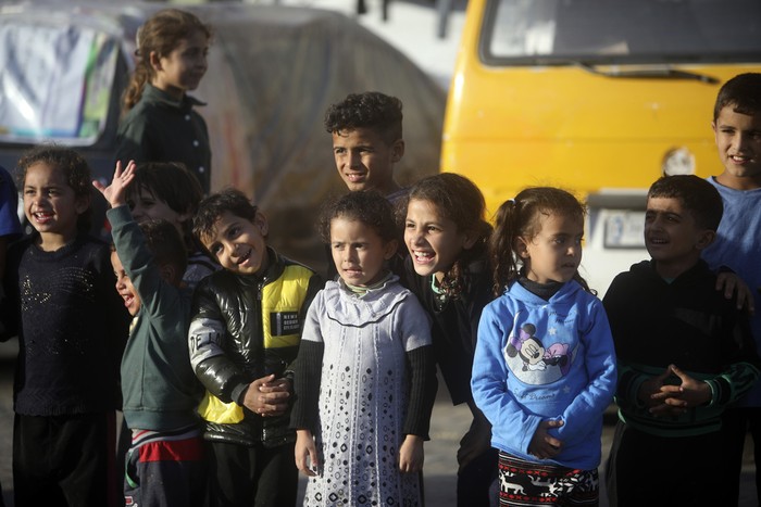 Palestinians present an entertainment performance for displaced children sheltering at a UN school in Rafah refugee camp, southern Gaza Strip, Thursday, Nov. 23, 2023. (AP Photo/Mohammed Dahman)