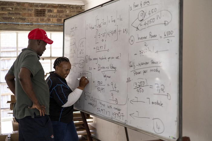 A trainer explains how a solar panel works during the theoretical part of the training at Nkangalas Top of the World Training Centre in Emalahleni on November 22, 2023. The centre created the first edition of the entrepreneurship training in November 2023, from a collaboration between local partners, the Renewable Energy Solutions for Africa (Res4Africa), a a foundation that works in support of Africas just energy transition, in order to implement the United Nations 