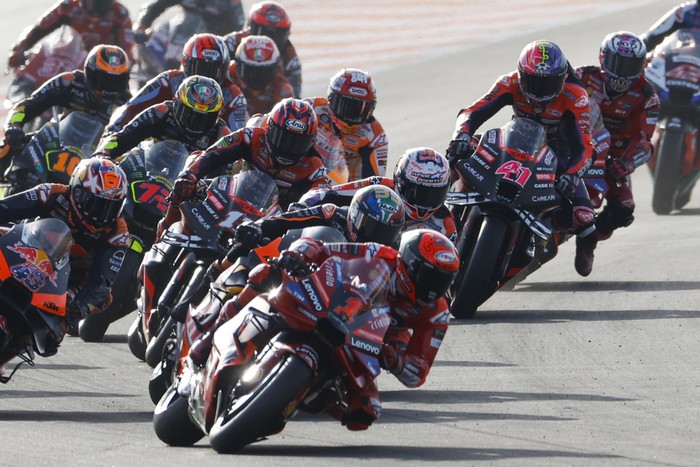 Italian rider Francesco Bagnaia of the Ducati Lenovo Team leads the pack at the start of the MotoGP race of the Valencia Motorcycle Grand Prix, the last race of the season, at the Ricardo Tormo circuit in Cheste near Valencia, Spain, Sunday, Nov. 26, 2023. (AP Photo/Alberto Saiz)