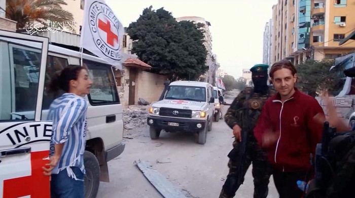 Hostages who were abducted by Hamas gunmen during the October 7 attack on Israel, are handed over by Hamas militants to members of the International Committee of the Red Cross, as part of a hostages-prisoners swap deal between Hamas and Israel amid a temporary truce, in an unknown location in the Gaza Strip, in this screengrab taken from video released November 26, 2023. Hamas Military Wing/Handout via REUTERS THIS IMAGE HAS BEEN SUPPLIED BY A THIRD PARTY WATERMARK FROM SOURCE.