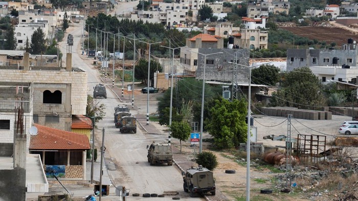 Israeli military vehicles manoeuvers on a road during a raid in Tubas in the Israeli-occupied West Bank November 28, 2023. REUTERS/Raneen Sawafta