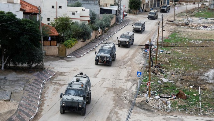 Israeli military vehicles manoeuvers on a road during a raid in Tubas in the Israeli-occupied West Bank November 28, 2023. REUTERS/Raneen Sawafta