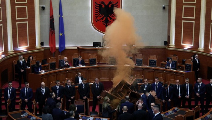 MPs of the Democratic Party, Albania's biggest opposition party, light coloured smoke bombs as a sign of protest during a parliament session in Tirana, Albania, December 4, 2023. REUTERS/Florion Goga     TPX IMAGES OF THE DAY