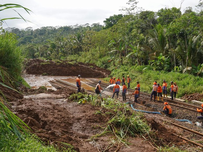 Petugas menyingkirkan material longsor yang menutup jalur rel kereta api di lintas stasiun Karanggandul-Karangsari, Banyumas, Jateng, Senin (4/12/2023). Perjalanan kereta api yang melintas di DAOP 5 Purwokerto, dialihkan memutar melalui Bandung atau Semarang imbas jalur kereta tertutup material longsor akibat curah hujan tinggi pada Senin (4/12/2024) dini hari. ANTARA FOTO/Idhad Zakaria/aww.