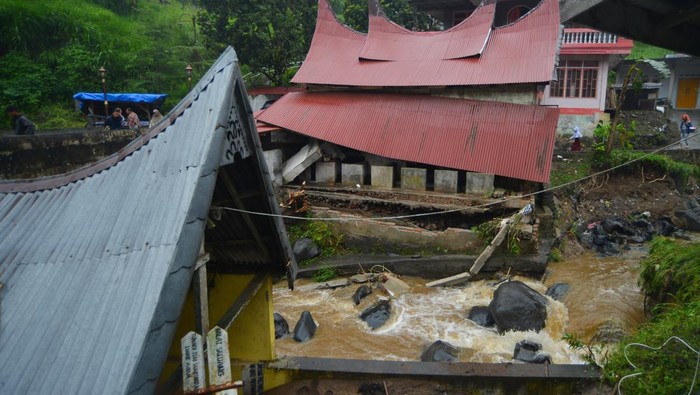 Warga melihat bangunan rusak akibat banjir bandang di Nagari Pariangan, Tanah Datar, Sumatera Barat, Rabu (6/12/2023).  Hujan lebat yang mengguyur hulu sungai lereng Gunung Marapi mengakibatkan banjir bandang yang menerjang sejumlah nagari di kabupaten itu. ANTARA FOTO/Iggoy el Fitra/rwa.