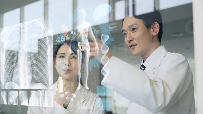 Medical occupations looking at glass screen. Medical technology. Biotechnology. Medtech.