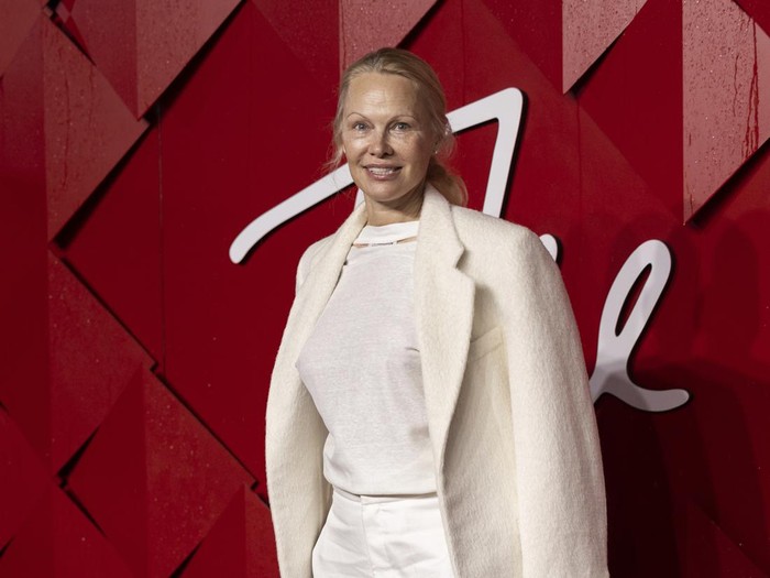 Pamela Anderson poses for photographers upon arrival at the British Fashion Awards on Monday, Dec. 4, 2023 in London. (Vianney Le Caer/Invision/AP)