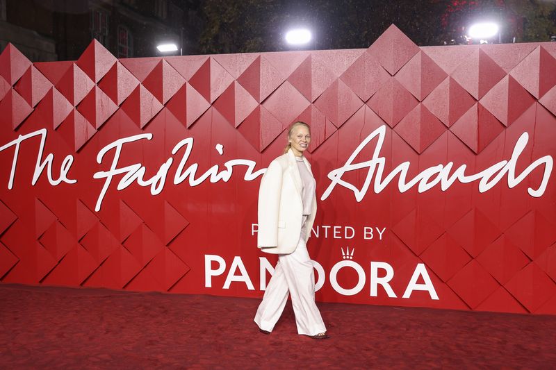 Pamela Anderson poses for photographers upon arrival at the British Fashion Awards on Monday, Dec. 4, 2023 in London. (Vianney Le Caer/Invision/AP)