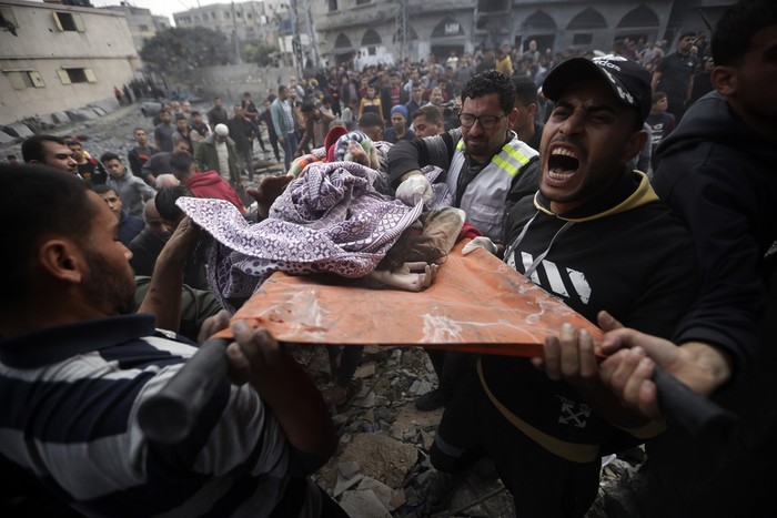 Palestinians carry a dead girl, found under the rubble of a destroyed building following Israeli airstrikes in Khan Younis refugee camp, southern Gaza Strip, Thursday, Dec. 7, 2023. (AP Photo/Mohammed Dahman)
