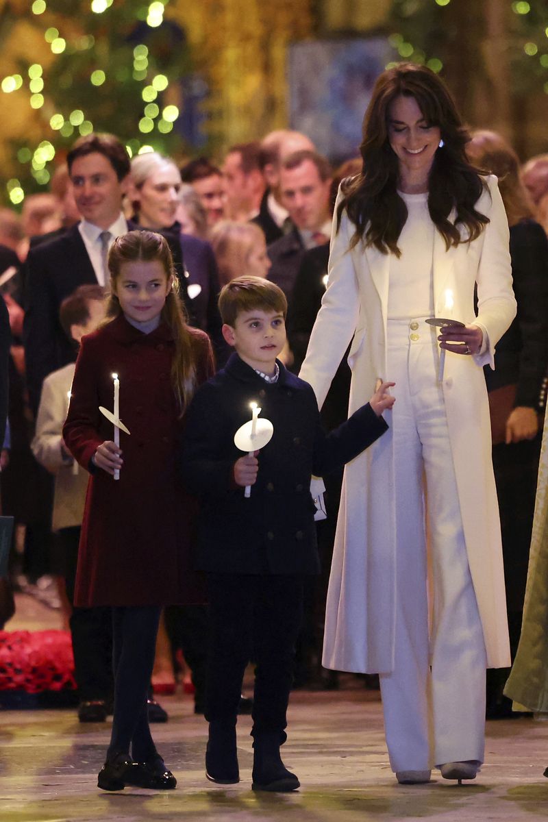 Britain's Kate, Princess of Wales, with her children Princess Charlotte and Prince Louis attend the Together At Christmas carol service at Westminster Abbey in London, Friday, Dec. 8, 2023. Spearheaded by The Princess of Wales and supported by The Royal Foundation, the service is a moment to bring people together at Christmas time and recognise those who have gone above and beyond to help others throughout the year. (Chris Jackson/Pool via AP)