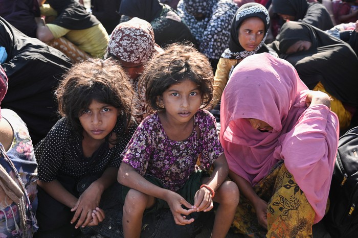 Rohingya Muslims rest on a beach after they land in Blang Raya, Pidie, Aceh province, Indonesia, December 10, 2023. REUTERS/Stringer NO RESALES. NO ARCHIVES