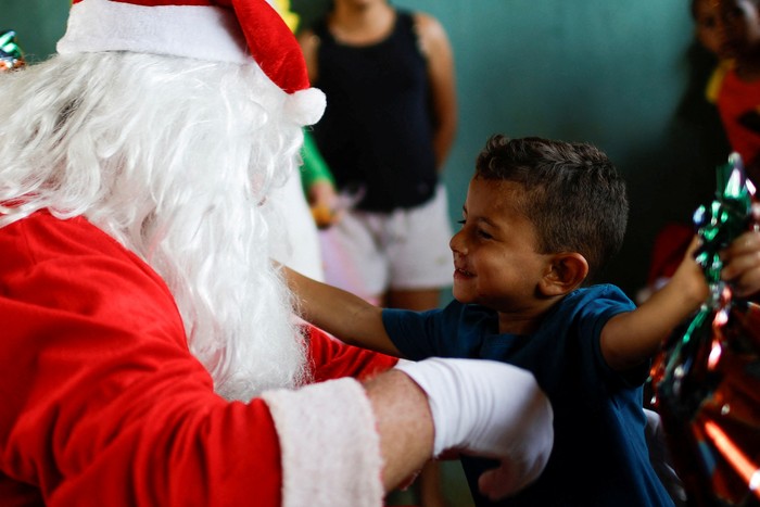 A motorcyclist, Helton Garcia dressed as Santa Claus, rides his motorcycle before handing out gifts to children in a rural school in Santo Antonio do Descoberto, state of Goias, Brazil December 10, 2023. REUTERS/Adriano Machado     TPX IMAGES OF THE DAY