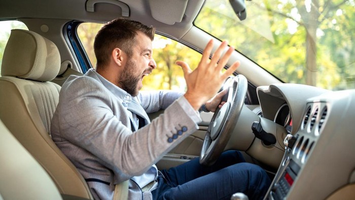 Really angry driver behind the steering wheel cannot keep his calmness