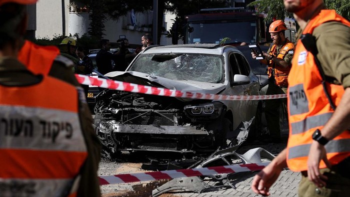 People inspect damage, following rockets attack that were fired from Gaza towards Israel amid the ongoing conflict between Israel and the Palestinian Islamist group Hamas, in Holon, Israel, December 11, 2023 REUTERS/Violeta Santos Moura