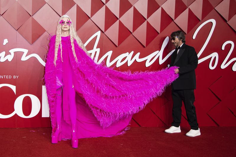 Kristen McMenamy and Pierpaolo Piccioli pose for photographers upon arrival at the British Fashion Awards in London, Monday, Dec. 5, 2022. (Photo by Vianney Le Caer/Invision/AP)