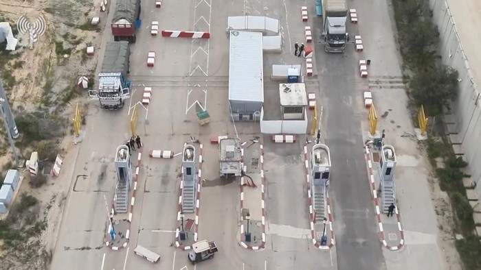 Humanitarian aid trucks wait in line to be inspected at the Kerem Shalom crossing, amid the ongoing conflict between Israel and the Palestinian Islamist group Hamas, on the border between Israel, Gaza and Egypt in this still image taken from video released December 12, 2023.    COGAT via X/Handout via REUTERS    THIS IMAGE HAS BEEN SUPPLIED BY A THIRD PARTY. NO RESALES. NO ARCHIVES. MANDATORY CREDIT. WATERMARK FROM SOURCE