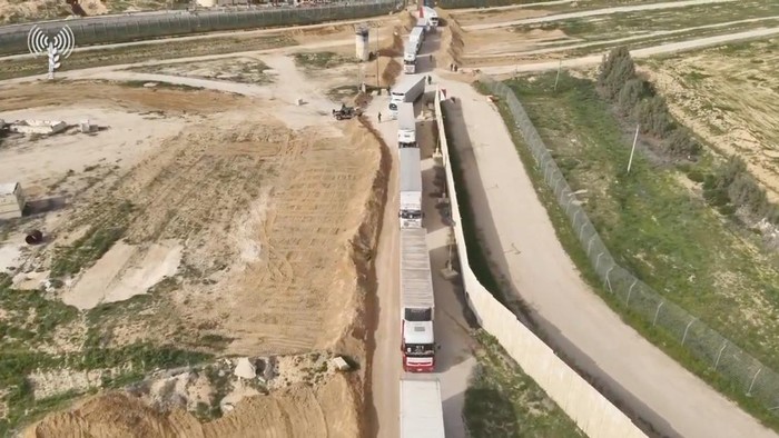 Humanitarian aid trucks wait in line to be inspected at the Kerem Shalom crossing, amid the ongoing conflict between Israel and the Palestinian Islamist group Hamas, on the border between Israel, Gaza and Egypt in this still image taken from video released December 12, 2023.    COGAT via X/Handout via REUTERS    THIS IMAGE HAS BEEN SUPPLIED BY A THIRD PARTY. NO RESALES. NO ARCHIVES. MANDATORY CREDIT. WATERMARK FROM SOURCE