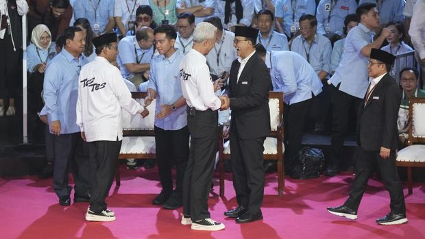 Presidential candidates Prabowo Subianto, left, his running mate Gibran Rakabuming Raka, third left, Ganjar Pranowo, fourth left, and his running mate Mahfud MD, second left, Anies Baswedan, second right, and his running mate Muhaimin Iskandar, right, greet each other before the start of the presidential candidates' debate in Jakarta, Indonesia, Tuesday, Dec. 12, 2023. (AP Photo/Tatan Syuflana)