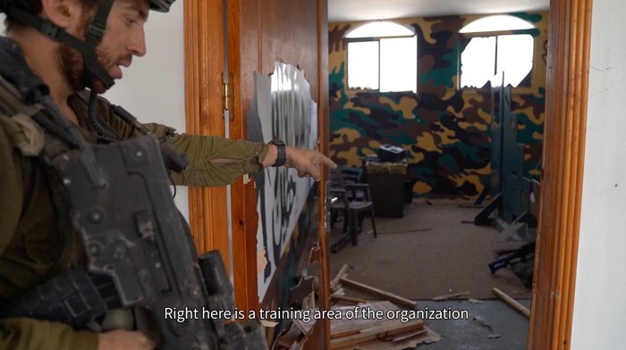 Klaim Israel Grebek Tempat Latihan Hamas di Masjid Gaza, Ini Potretnya An Israeli soldier points to what the Israeli army says it is a training area, inside a mosque in Jabalia, in the northern Gaza Strip, in this screengrab taken from video released on December 11, 2023. Israel Defense Forces/Handout via REUTERS THIS IMAGE HAS BEEN SUPPLIED BY A THIRD PARTY. TEXT ON VIDEO FROM SOURCE.