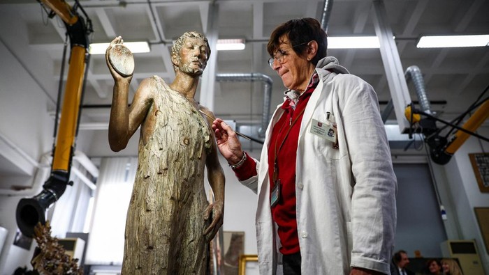 Restorer Rossana Giardina works on an artwork at the 