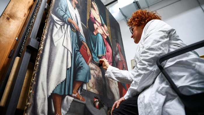 Restorer Rossana Giardina works on an artwork at the 