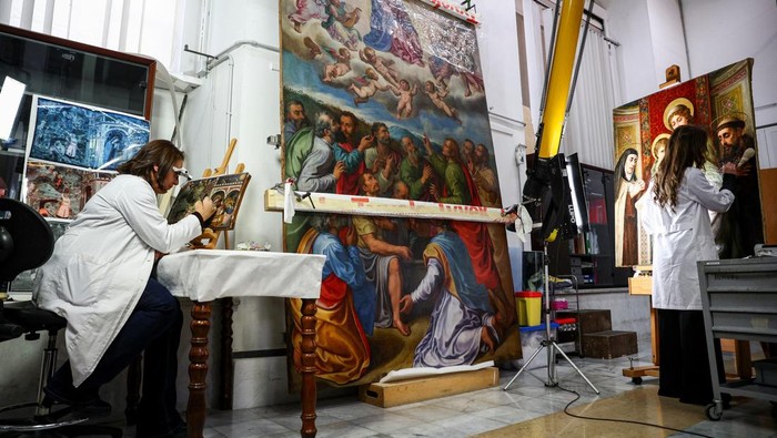 Restorer Rossana Giardina works on an artwork at the 