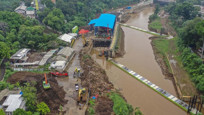 Petugas kebersihan DKI Jakarta menebar pupuk kompos ke tanaman kangkung di kawasan Saringan Sampah segmen TB Simatupang, Jagakarsa, Jakarta.
