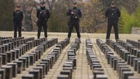 Petugas polisi berdiri di dekat hasil tangkapan 11 ton kokain, yang dipajang di teras kantor polisi di Madrid, Spanyol, Selasa (12/12/2023).  