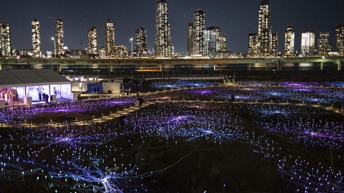 People walk in the public art installation 