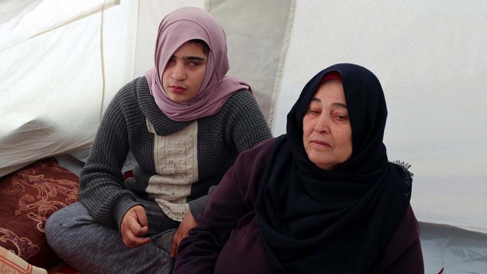 Palestinian autistic teenager Mustasem lays on a carpet, after fleeing his home with his autistic twin Sujood, his mother Asma Abu Abed and his grandmother, due to Israeli strikes, to shelter in a tent in Rafah, in the southern Gaza Strip, December 12, 2023. REUTERS/Saleh Salem