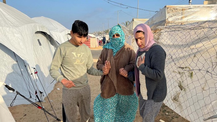Palestinian autistic teenager Mustasem lays on a carpet, after fleeing his home with his autistic twin Sujood, his mother Asma Abu Abed and his grandmother, due to Israeli strikes, to shelter in a tent in Rafah, in the southern Gaza Strip, December 12, 2023. REUTERS/Saleh Salem