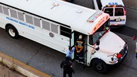 Tampak mereka dibawa dengan bus polisi.  