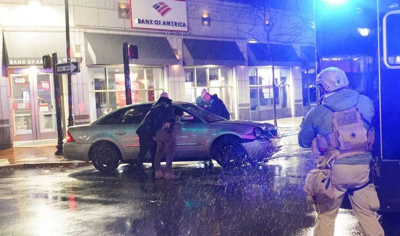 Members of the United States Secret Service react to a vehicle crashing into a Secret Service SUV that was blocking the street as U.S. President Joe Biden exited his campaign headquarters, in Wilmington, Delaware, U.S. December 17, 2023. REUTERS/Nathan Howard Acquire Licensing Rights