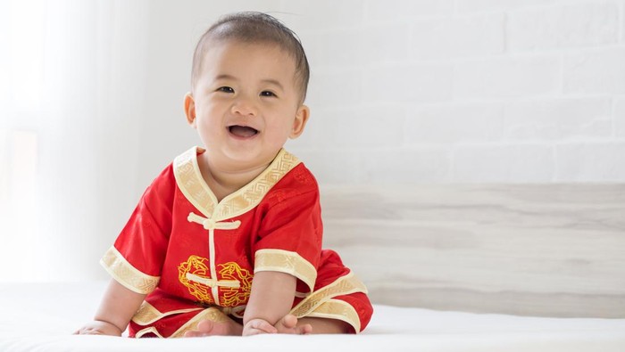 Asian baby boy smiling with traditional Chinese outfit. Dress up for Chinese new year festival concept