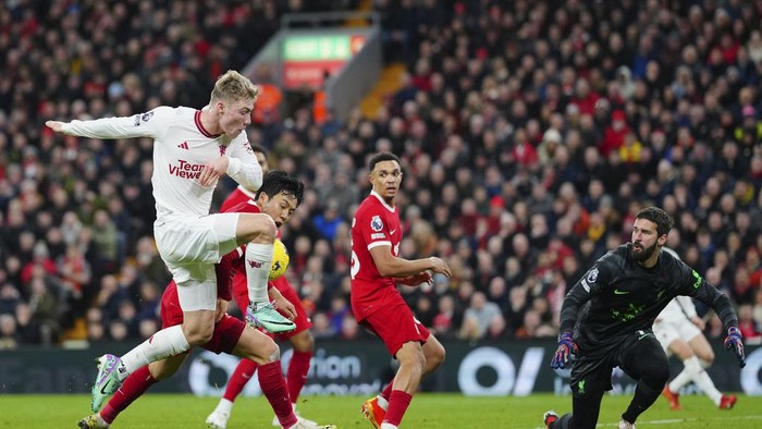 Manchester Uniteds Rasmus Hojlund, left, shoots the ball during the English Premier League soccer match between Liverpool and Manchester United at the Anfield stadium in Liverpool, England, Sunday, Dec.17, 2023. (AP Photo/Jon Super)