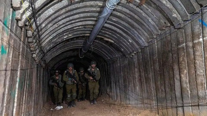 Israeli soldiers walk through what Israels military says is an iron-girded tunnel designed by Hamas to disgorge carloads of Palestinian fighters for a surprise storming of the border, amid the Israeli armys ongoing ground operation against Palestinian Islamist group Hamas, close to Erez crossing in the northern Gaza Strip, December 15, 2023. REUTERS/Amir Cohen Acquire Licensing Rights