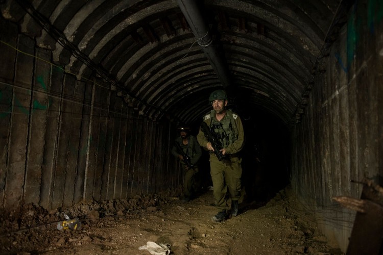 NORTHERN GAZA, GAZA- DECEMBER 15: An Israeli soldier exits a tunnel near the border with Israel on December 15, 2023 in northern Gaza Strip. The Israel Defense Forces say this is the largest tunnel theyve found yet in Gaza, comprising branches that extend well over four kilometers (2.5 miles) and reaches 400 meters (1,310 feet) from the Erez crossing. The IDF alleges the project of building the tunnel was led by Mohammed Sinwar, the brother of Hamas leader Yahya Sinwar and was used as part of the Oct. 7 attack, funnelling fighters near the Erez crossing and Israeli border communities. As the IDF have pressed into Gaza as part of their campaign to defeat Hamas, they have highlighted the militant groups extensive tunnel network as emblematic of the way the group embeds itself and its military activity in civilian areas. (Photo by Amir Levy/Getty Images)