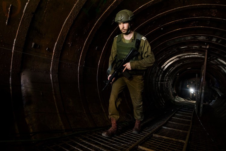 NORTHERN GAZA, GAZA- DECEMBER 15: An Israeli soldier exits a tunnel near the border with Israel on December 15, 2023 in northern Gaza Strip. The Israel Defense Forces say this is the largest tunnel theyve found yet in Gaza, comprising branches that extend well over four kilometers (2.5 miles) and reaches 400 meters (1,310 feet) from the Erez crossing. The IDF alleges the project of building the tunnel was led by Mohammed Sinwar, the brother of Hamas leader Yahya Sinwar and was used as part of the Oct. 7 attack, funnelling fighters near the Erez crossing and Israeli border communities. As the IDF have pressed into Gaza as part of their campaign to defeat Hamas, they have highlighted the militant groups extensive tunnel network as emblematic of the way the group embeds itself and its military activity in civilian areas. (Photo by Amir Levy/Getty Images)