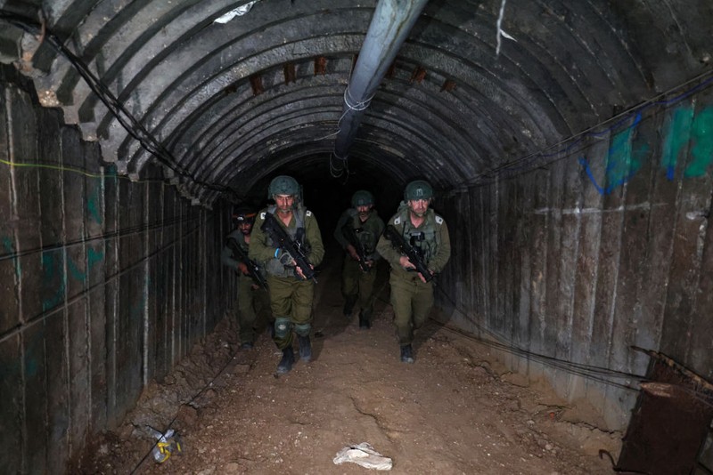 In this picture taken during a media tour organised by the Israeli military on December 15, 2023, soldiers visit a tunnel that Hamas reportedly used to attack Israel through the Erez border crossing on October 7. The Israeli army said on December 17, 2023 it had uncovered the biggest Hamas tunnel in the Gaza Strip so far, just a few hundred metres from the Erez border crossing. (Photo by JACK GUEZ / AFP) (Photo by JACK GUEZ/AFP via Getty Images)