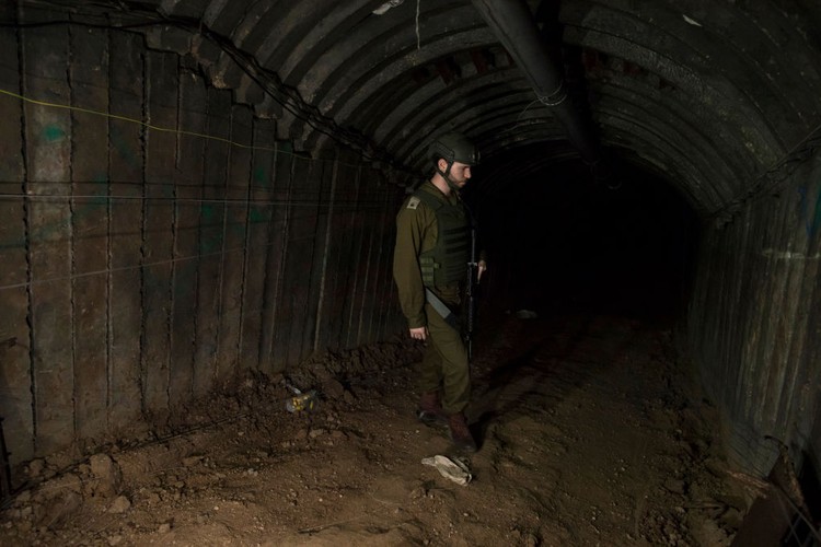 NORTHERN GAZA, GAZA- DECEMBER 15: An Israeli soldier walks through a tunnel near the border with Israel on December 15, 2023 in northern Gaza Strip. The Israel Defense Forces say this is the largest tunnel theyve found yet in Gaza, comprising branches that extend well over four kilometers (2.5 miles) and reaches 400 meters (1,310 feet) from the Erez crossing. The IDF alleges the project of building the tunnel was led by Mohammed Sinwar, the brother of Hamas leader Yahya Sinwar and was used as part of the Oct. 7 attack, funnelling fighters near the Erez crossing and Israeli border communities. As the IDF have pressed into Gaza as part of their campaign to defeat Hamas, they have highlighted the militant groups extensive tunnel network as emblematic of the way the group embeds itself and its military activity in civilian areas. (Photo by Amir Levy/Getty Images)