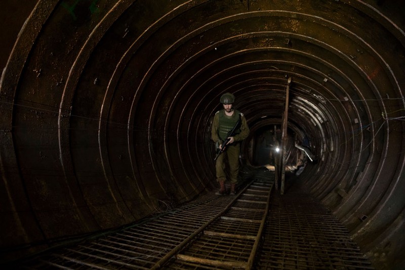 NORTHERN GAZA, GAZA- DECEMBER 15: An Israeli soldier walks through a tunnel near the border with Israel on December 15, 2023 in northern Gaza Strip. The Israel Defense Forces say this is the largest tunnel they've found yet in Gaza, comprising branches that extend well over four kilometers (2.5 miles) and reaches 400 meters (1,310 feet) from the Erez crossing. The IDF alleges the project of building the tunnel was led by Mohammed Sinwar, the brother of Hamas leader Yahya Sinwar and was used as part of the Oct. 7 attack, funnelling fighters near the Erez crossing and Israeli border communities. As the IDF have pressed into Gaza as part of their campaign to defeat Hamas, they have highlighted the militant group's extensive tunnel network as emblematic of the way the group embeds itself and its military activity in civilian areas. (Photo by Amir Levy/Getty Images)