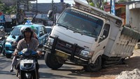 Sebuah truk terperosok di Jl Cirendeu Raya, Tangsel, Banten, Selasa (19/12/2023) pukul 09.30 WIB.