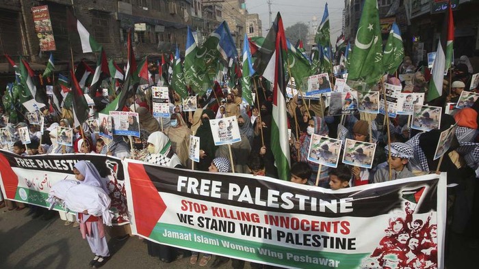 Women and children participate in a rally in Peshawar, Pakistan, Wednesday, Dec. 20, 2023 called by a Pakistani religious group 'Jamaat-e-Islami' against the Israeli airstrikes on Gaza, and to show solidarity with Palestinian people. (AP Photo/Muhammad Sajjad)