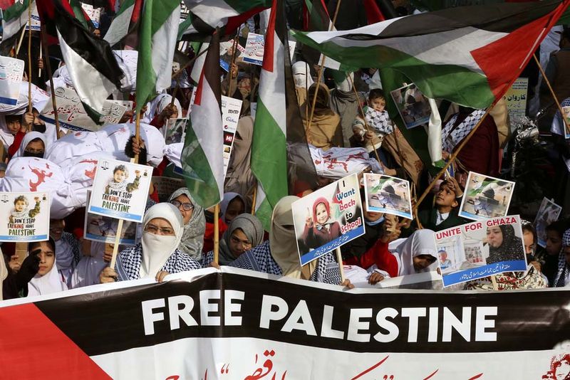 Women and children participate in a rally in Peshawar, Pakistan, Wednesday, Dec. 20, 2023 called by a Pakistani religious group 'Jamaat-e-Islami' against the Israeli airstrikes on Gaza, and to show solidarity with Palestinian people. (AP Photo/Muhammad Sajjad)