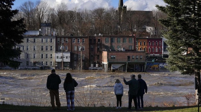 Cars are flooded in a parking lot at the Hathaway Creative Center alongside the Kennebec River, Tuesday, Dec. 19, 2023, in Waterville, Maine. A severe storm on Monday flooded rivers and knocked out power to hundreds of thousands. (AP Photo/Robert F. Bukaty)